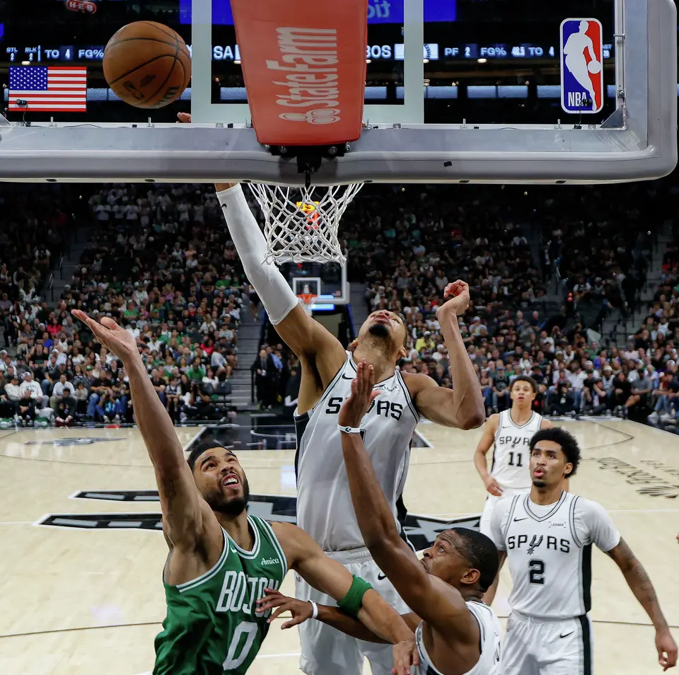 Boston Celtics forward Jayson Tatum (0) makes a shot over San Antonio Spurs forward Victor Wembanyama (1) and guard De'aaron Fox (4) during the fourth quarter at Frost Bank Center in San Antonio, Tuesday, March 10, 2026. The Spurs defeated the Celtics 125-116.