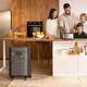 Family making breakfast in the kitchen using a Jackery's Solar Generator 5000 Plus home backup power station for power.