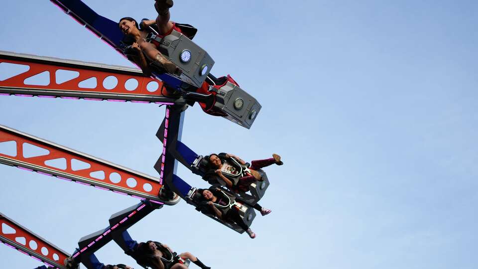 Thrill-seekers enjoy one of the rides at the Houston Rodeo and Livestock Show in Houston on Monday, March 9, 2026.