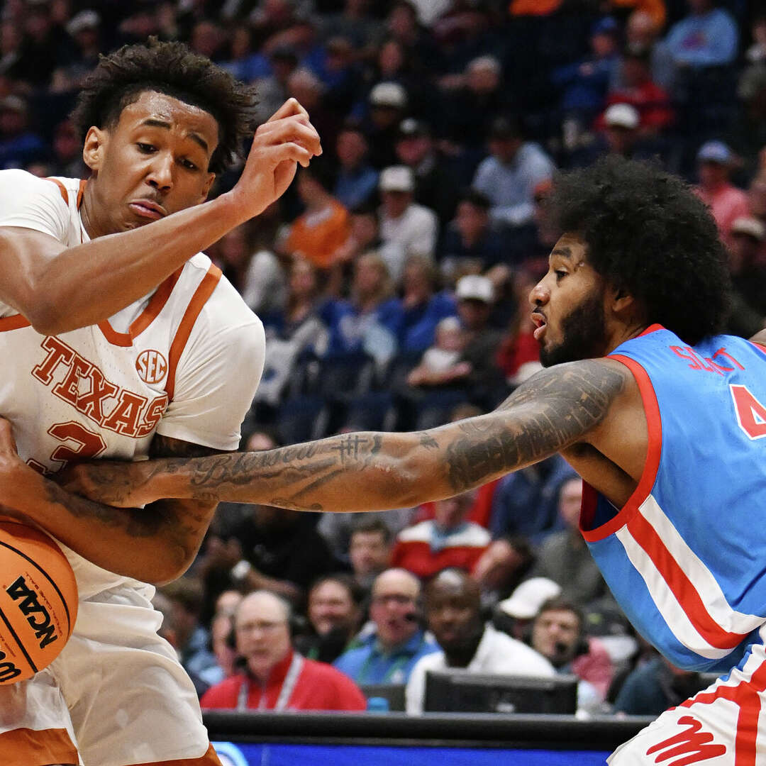 James Scott #4 of the Ole Miss Rebels knocks the ball away from Dailyn Swain #3 of the Texas Longhorns during the first half in the first round of the 2026 SEC Men's Basketball Tournament at Bridgestone Arena on March 11, 2026 in Nashville, Tennessee.