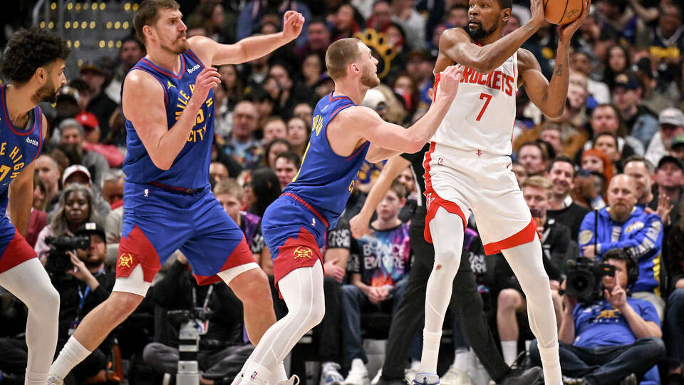 Nuggets defenders like Nikola Jokic (left) and Christian Braun were quick to pressure the Rockets' Kevin Durant during Houston's blowout loss Wednesday in Denver.