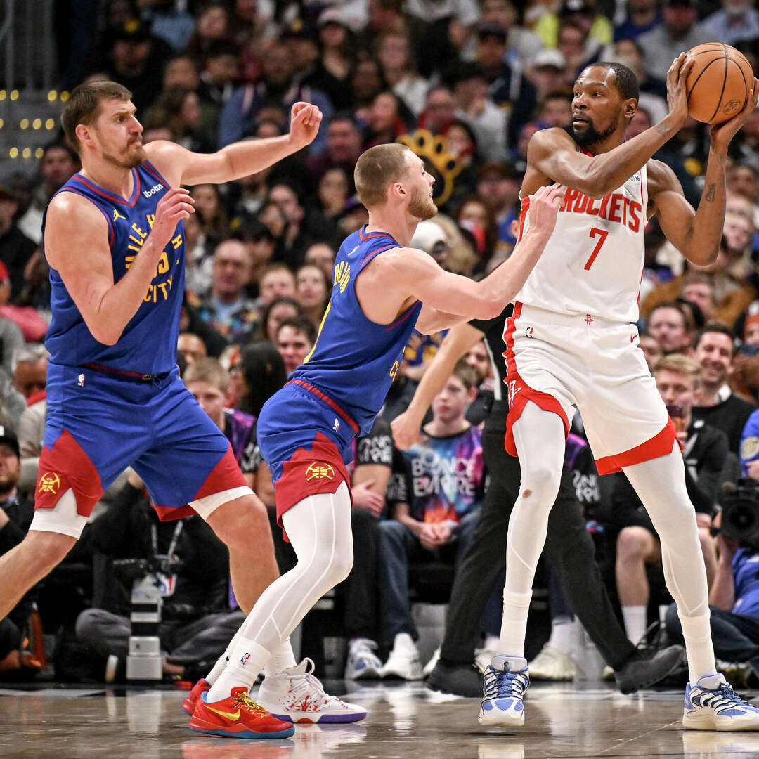 Nuggets defenders like Nikola Jokic (left) and Christian Braun were quick to pressure the Rockets' Kevin Durant during Houston's blowout loss Wednesday in Denver.