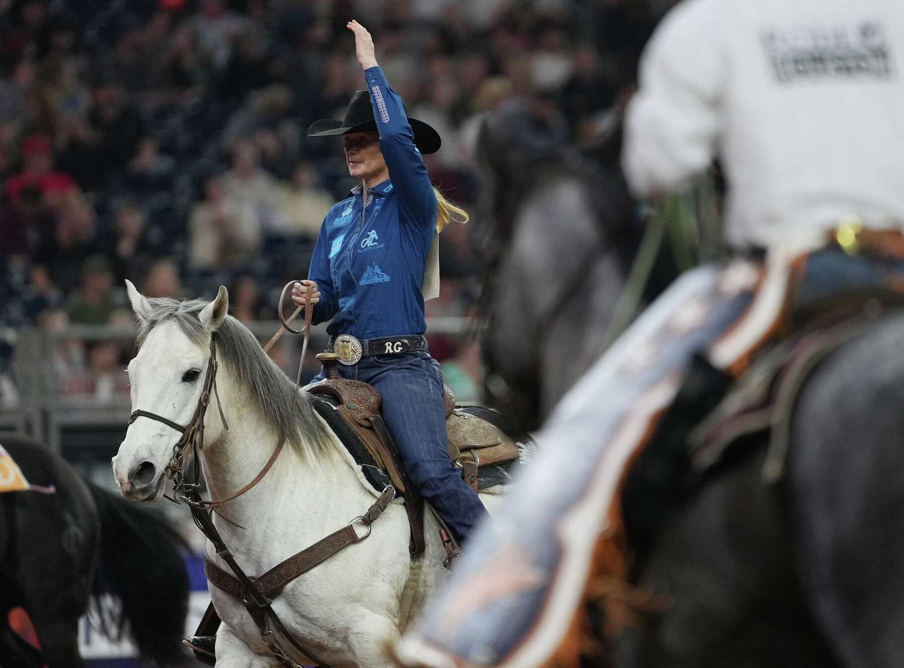 Rylee George acknowledges the crowd after roping a steer in 3.1 seconds in the Breakaway Roping event at RodeoHouston at NRG Stadium in Houston on Wednesday, March 11, 2026.