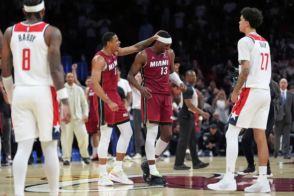 Miami Heat center Bam Adebayo (13) is congratulated by forward Keshad Johnson (16) after reaching 83 points, the second-highest single game total in NBA history, in the second half of an NBA basketball game against the Washington Wizards, Tuesday, March 10, 2026, in Miami. (AP Photo/Rebecca Blackwell)