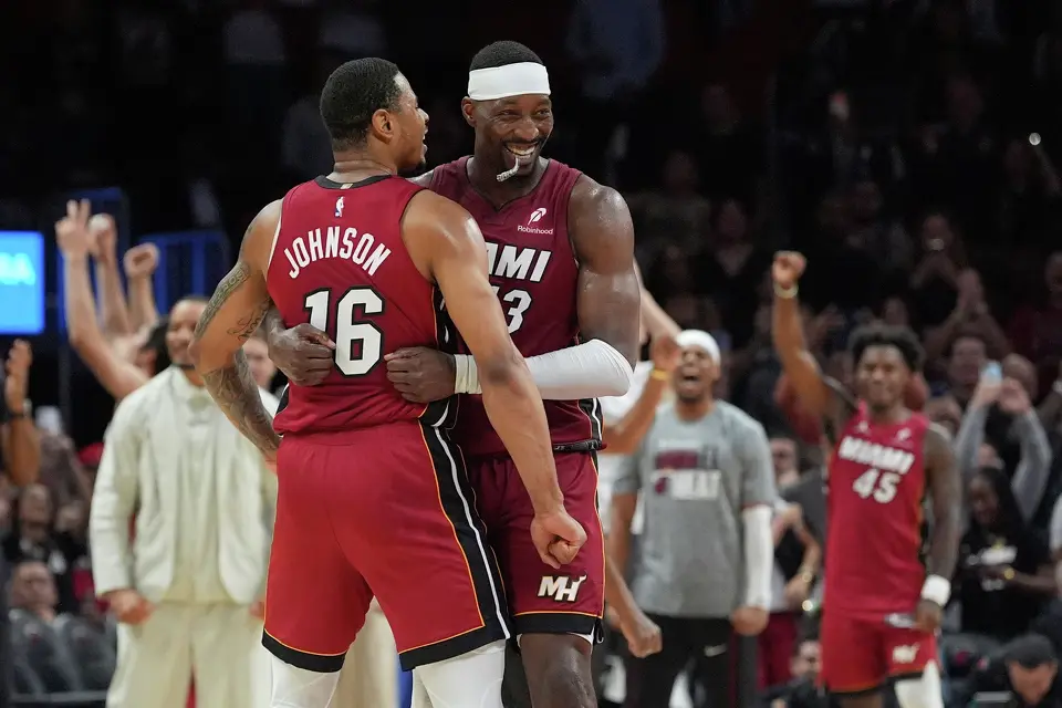 Miami Heat center Bam Adebayo (13) celebrates with forward Keshad Johnson (16) after reaching 83 points, the second-highest single game total in NBA history, in the second half of an NBA basketball game against the Washington Wizards, Tuesday, March 10, 2026, in Miami. (AP Photo/Rebecca Blackwell)