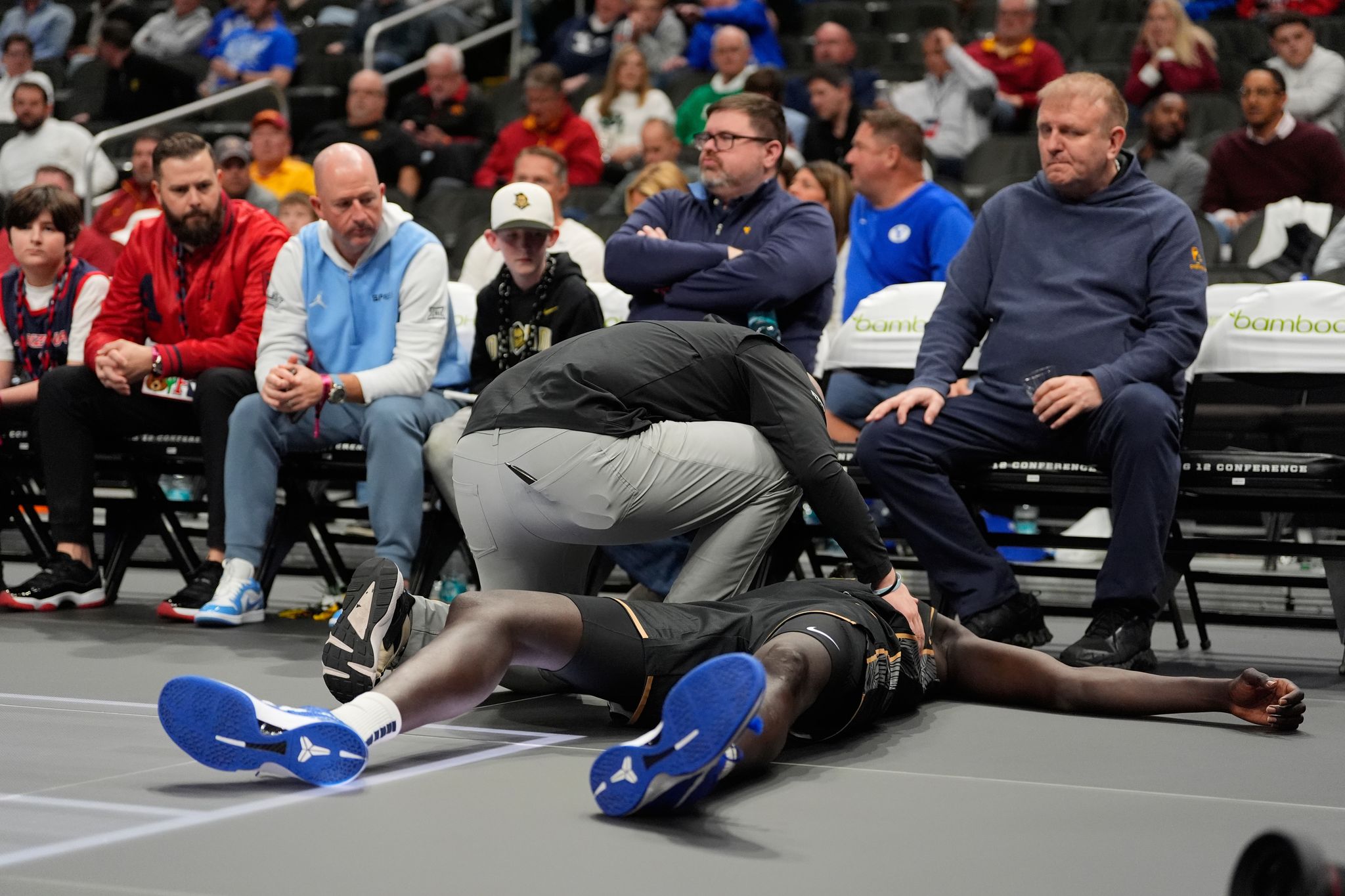 UCF's John Bol helped off court after collapsing and clutching his ...