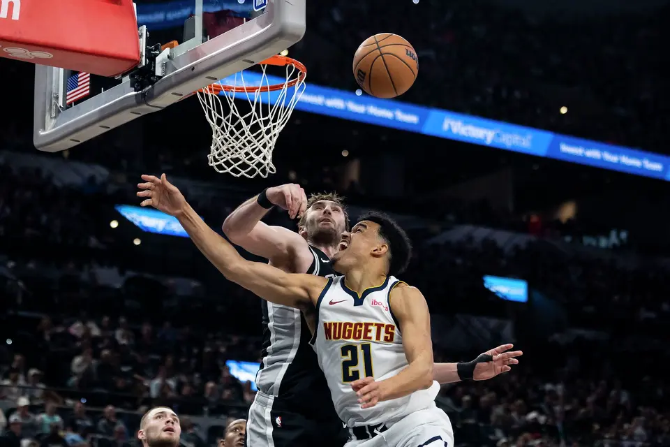 San Antonio Spurs center Luke Kornet (7) blocks the ball from Denver Nuggets forward Spencer Jones (21) at Frost Bank Center in San Antonio on Thursday, March 12, 2026.