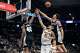 San Antonio Spurs forward Harrison Barnes, left, Denver Nuggets center Nikola Jokic, center, and San Antonio Spurs forward Carter Bryant, right, battle for a rebound at the Frost Bank Center in San Antonio on Thursday, March 12, 2026.