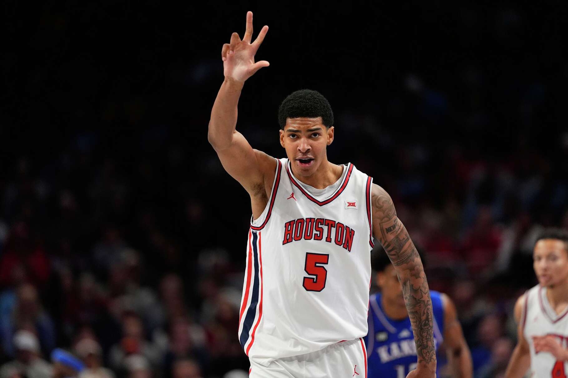 Houston's Chris Cenac Jr. celebrates after making a 3-point basket during the first half of an NCAA college basketball game against Kansas in the semifinal round of the Big 12 Conference tournament Friday, March 13, 2026, in Kansas City, Mo. (AP Photo/Charlie Riedel)