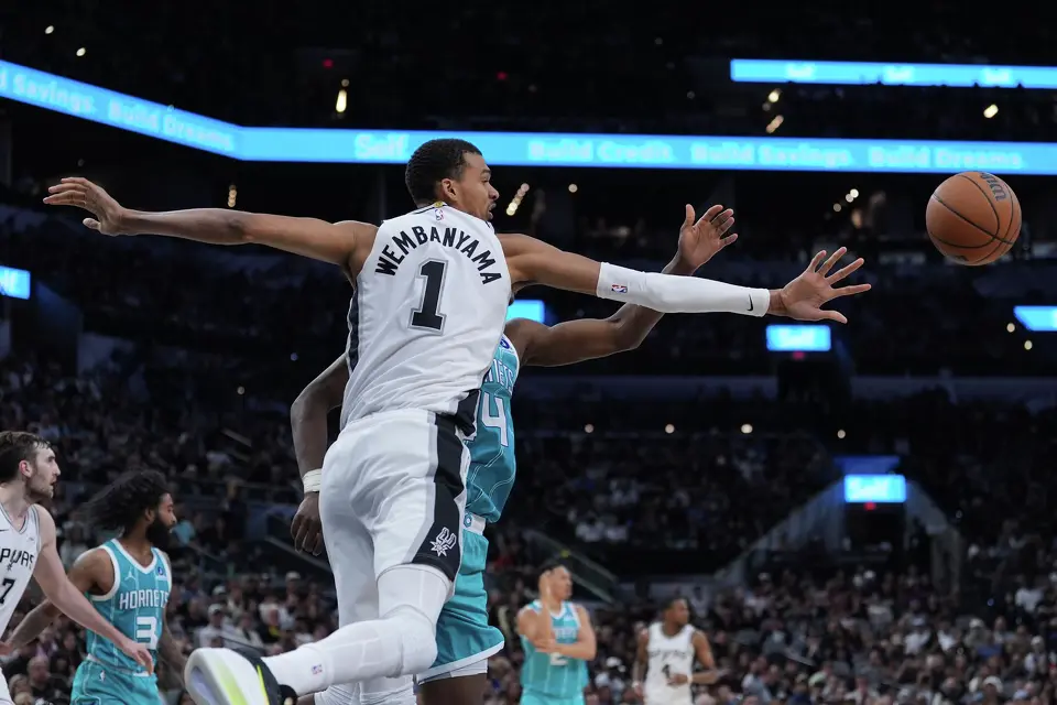 San Antonio Spurs forward Victor Wembanyama (1) and Charlotte Hornets forward Moussa Diabate (14) chase a rebound during the second half of an NBA basketball game in San Antonio, Saturday, March 14, 2026. (AP Photo/Eric Gay)