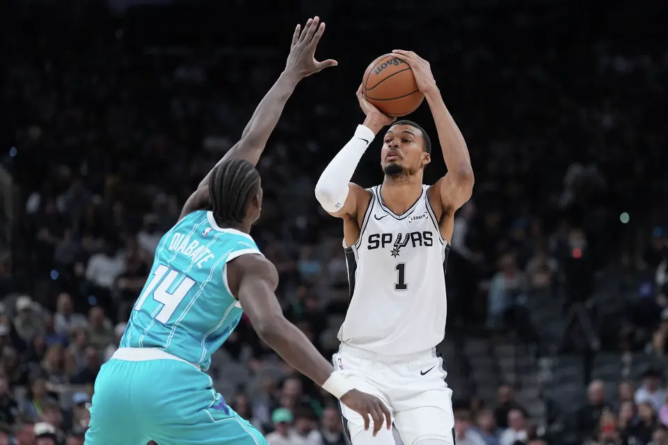 San Antonio Spurs forward Victor Wembanyama (1) shoots over Charlotte Hornets forward Moussa Diabate (14) during the first half of an NBA basketball game in San Antonio, Saturday, March 14, 2026. (AP Photo/Eric Gay)