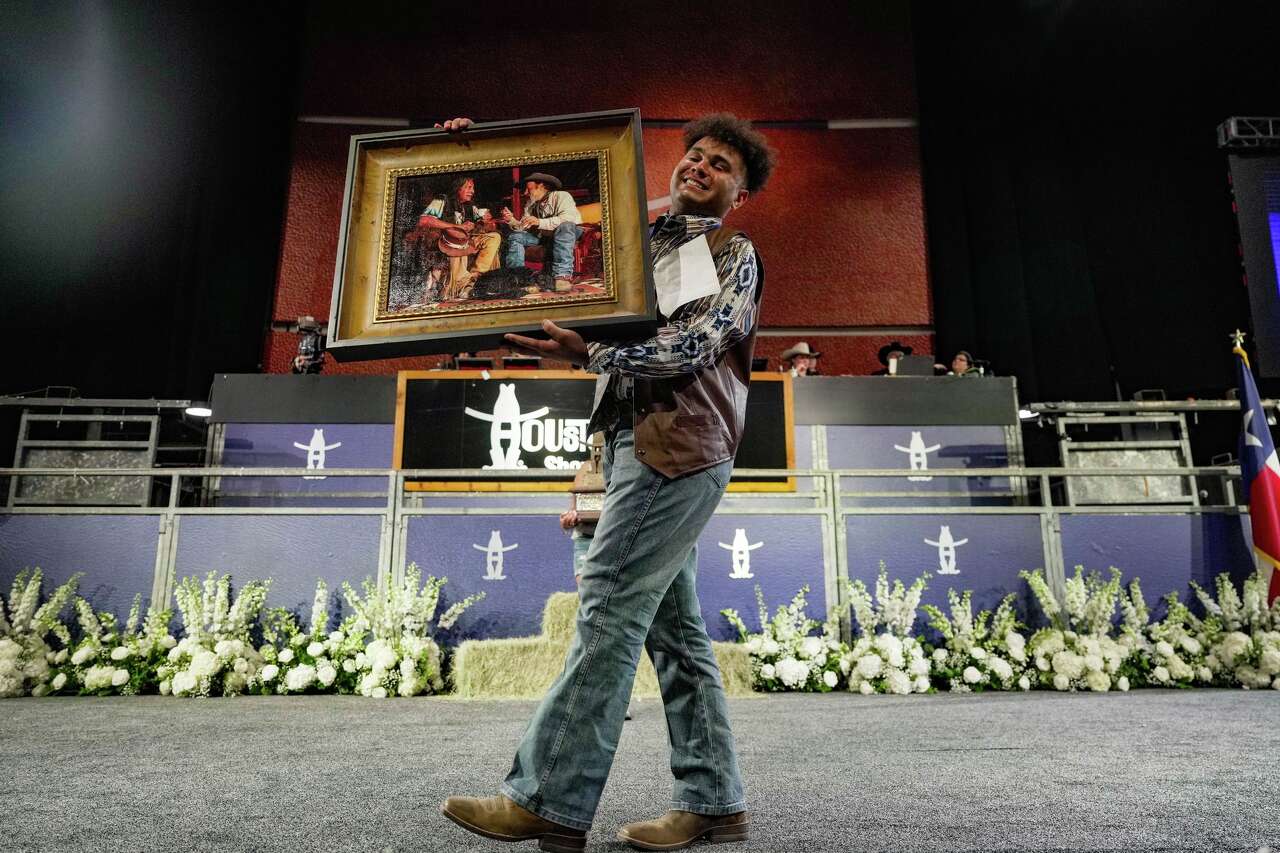 Joshua Washington showcases his artwork after being named Grand Champion at the Houston Livestock Show and Rodeo School Art Auction at NRG Center in Houston on Thursday, March 12, 2026.