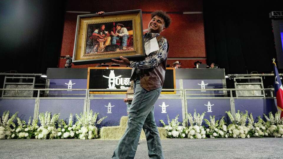 Joshua Washington showcases his artwork after being named Grand Champion at the Houston Livestock Show and Rodeo School Art Auction at NRG Center in Houston on Thursday, March 12, 2026.