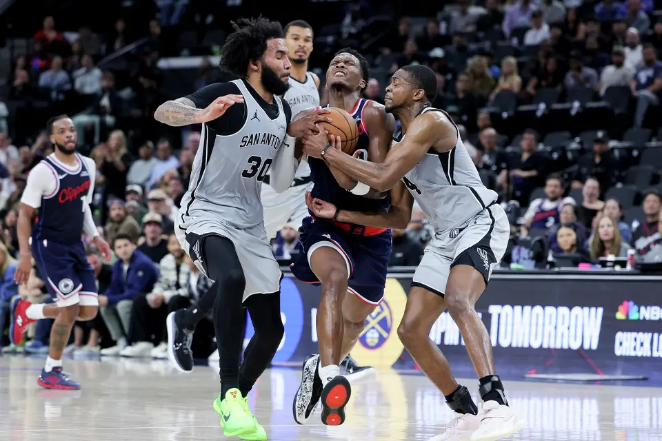 Los Angeles Clippers guard Bennedict Mathurin, center, drives against San Antonio Spurs forward Julian Champagnie, left, and guard De'Aaron Fox during the second half of an NBA basketball game Monday, March 16, 2026, in Inglewood, Calif. (AP Photo/Ryan Sun)