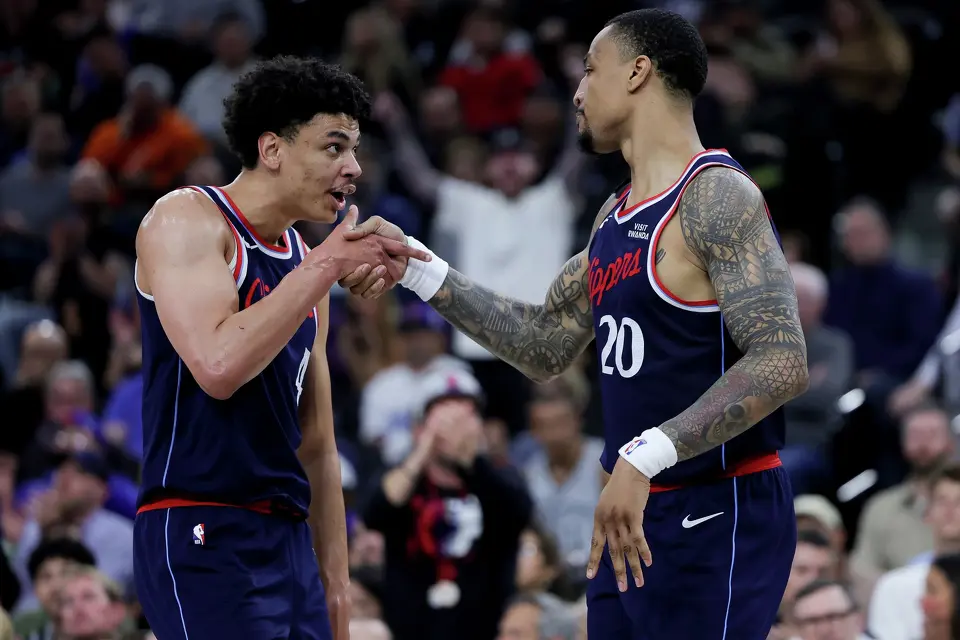 Los Angeles Clippers guard Kobe Sanders, left, reacts with forward John Collins during the second half of an NBA basketball game against the San Antonio Spurs Monday, March 16, 2026, in Inglewood, Calif. (AP Photo/Ryan Sun)