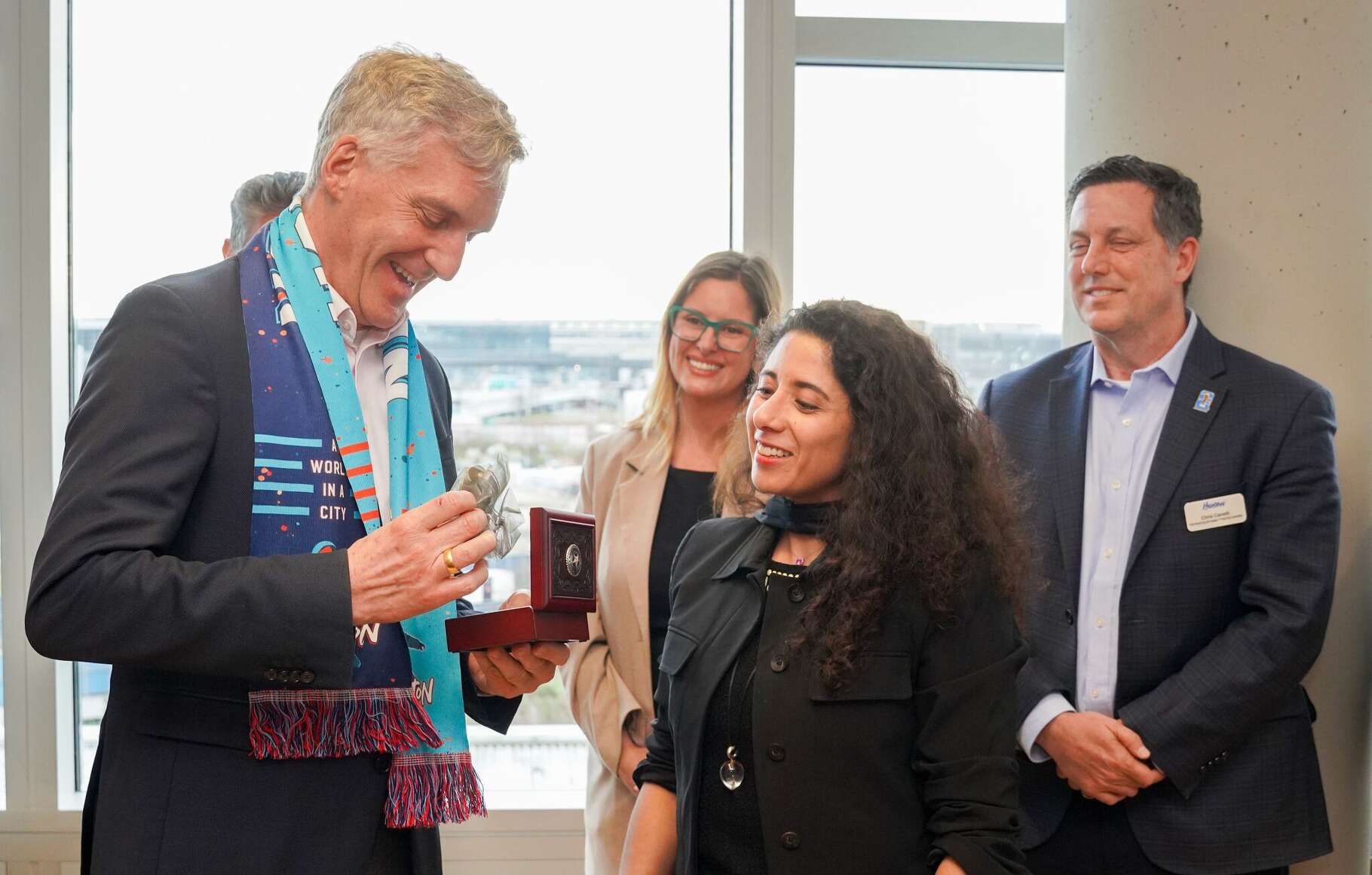 Harris County Judge Lina Hidalgo presents a Texas-themed belt buckle to Eric Menges, the CEO of Frankfurt RheinMain GmbH, during a trade mission to Europe.