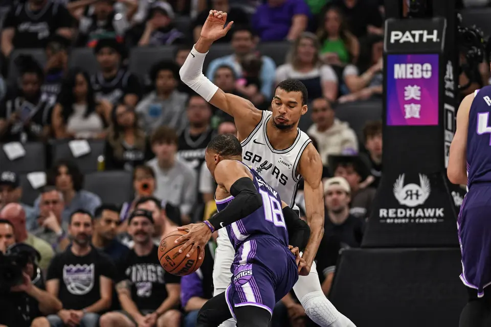 San Antonio Spurs forward Victor Wembanyama (1) defends Sacramento Kings guard Russell Westbrook (18) during the first half of an NBA basketball game, Tuesday, March 17, 2026, in Sacramento, Calif.