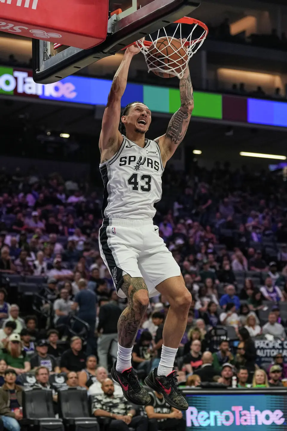 San Antonio Spurs forward Lindy Waters III (43) dunks the ball during the first half of an NBA basketball game against the Sacramento Kings, Tuesday, March 17, 2026, in Sacramento, Calif. (AP Photo/Justine Willard)
