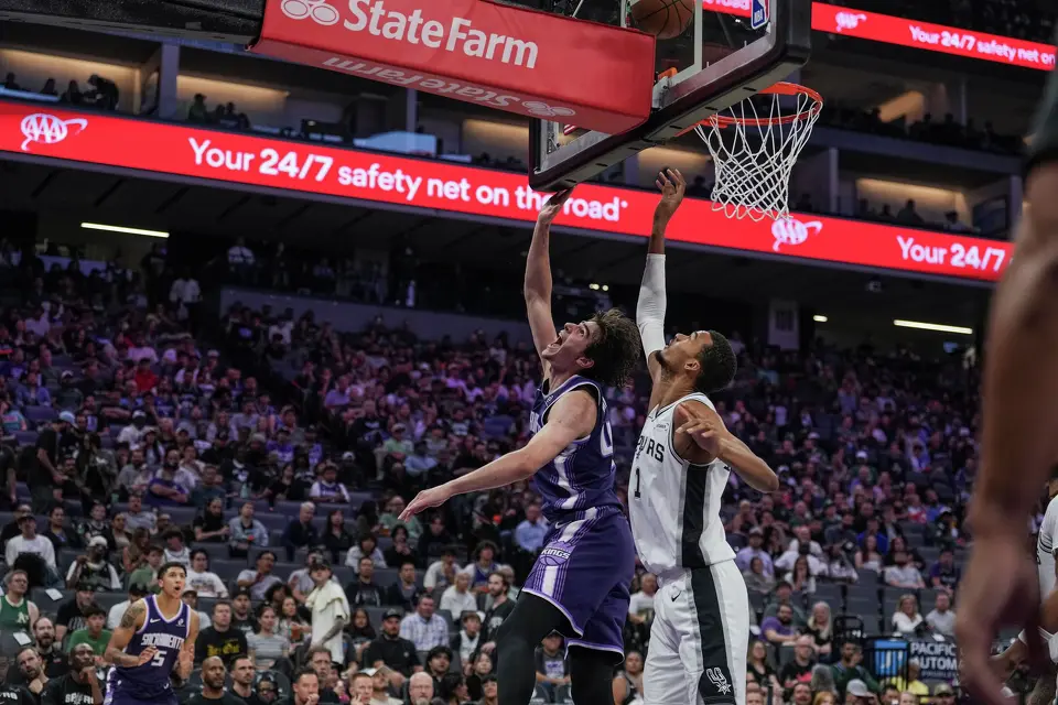 Sacramento Kings center Maxime Raynaud (42) is fouled by San Antonio Spurs forward Victor Wembanyama (1) during the second half of an NBA basketball game, Tuesday, March 17, 2026, in Sacramento, Calif. (AP Photo/Justine Willard)