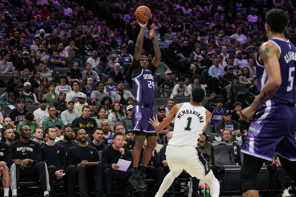 Sacramento Kings guard Daeqwon Plowden (29) shoots a 3 point basket over San Antonio Spurs forward Victor Wembanyama (1) during the second half of an NBA basketball game, Tuesday, March 17, 2026, in Sacramento, Calif. (AP Photo/Justine Willard)