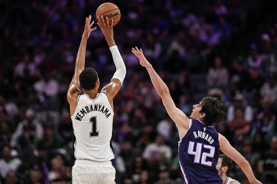 San Antonio Spurs forward Victor Wembanyama (1) shoots over Sacramento Kings center Maxime Raynaud (42) during the second half of an NBA basketball game, Tuesday, March 17, 2026, in Sacramento, Calif. (AP Photo/Justine Willard)