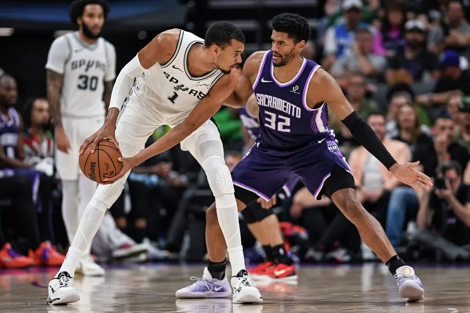 Sacramento Kings center Dylan Cardwell (32) defends San Antonio Spurs forward Victor Wembanyama (1) during the second half of an NBA basketball game, Tuesday, March 17, 2026, in Sacramento, Calif. (AP Photo/Justine Willard)