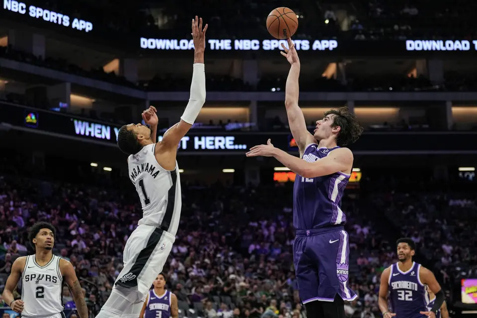 Sacramento Kings center Maxime Raynaud (42) shoots over San Antonio Spurs forward Victor Wembanyama (1) during the second half of an NBA basketball game, Tuesday, March 17, 2026, in Sacramento, Calif. (AP Photo/Justine Willard)