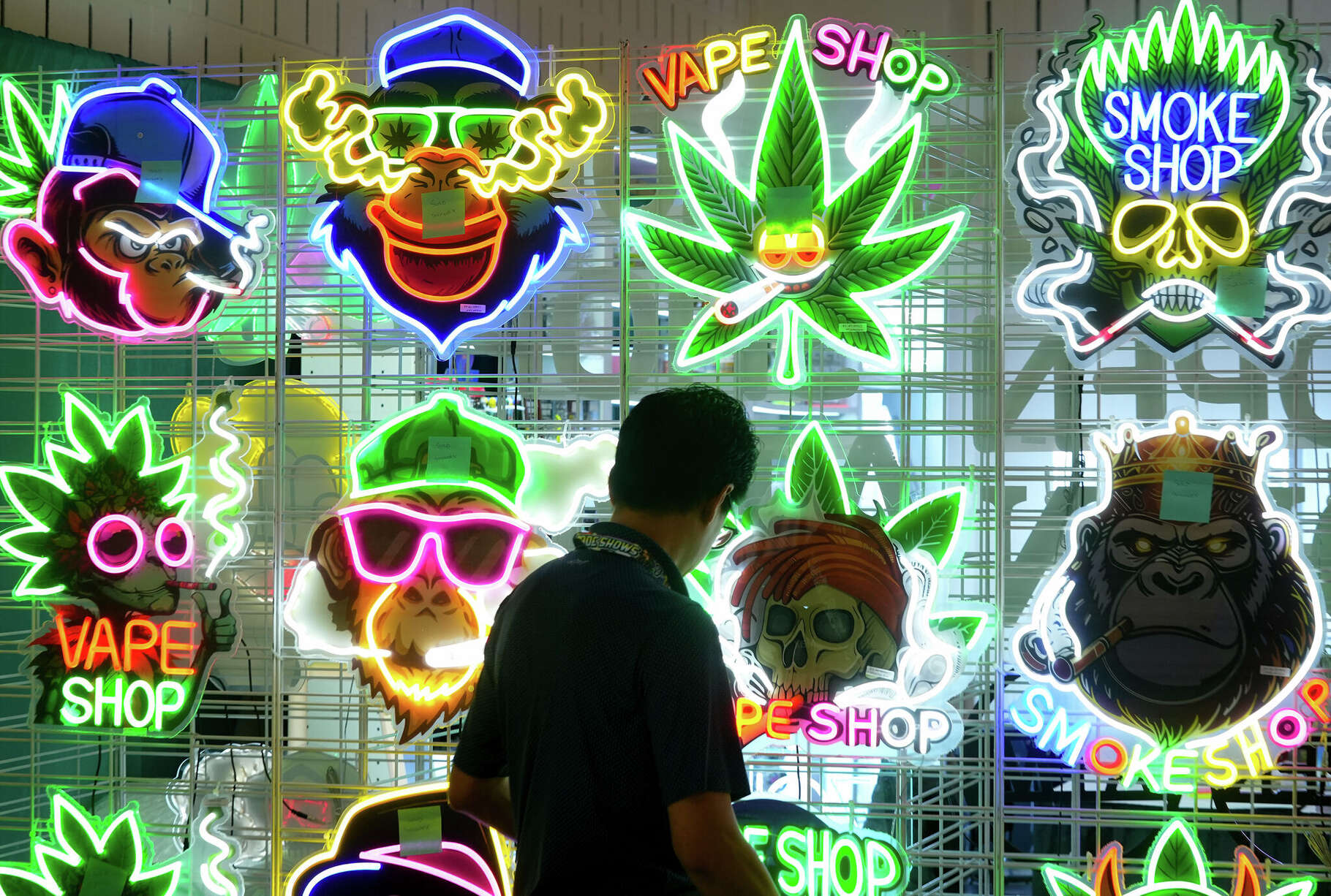 Mike Uchka, of CaraMax Corporation, displays lighted signs at CHAMPS Trade Show at the Palmer Events Center Thursday, Sept. 11, 2025. The three-day business-to-business trade show focuses on the counterculture, smoke shop, and cannabis-related industries.