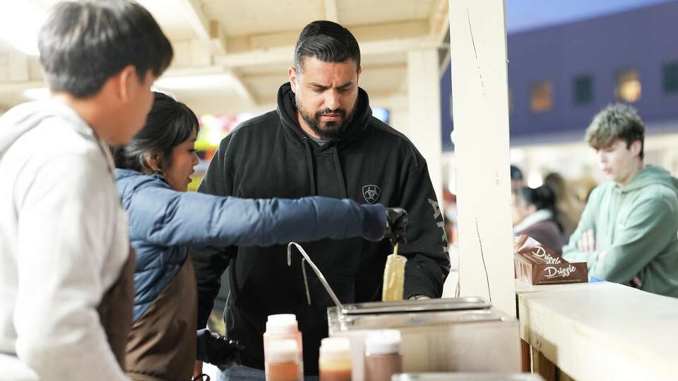 Stephen El Gidi runs his food stall, Drizzle Cheesecakes, at Houston Livestock Show and Rodeo in Houston on Tuesday, March 17, 2026.