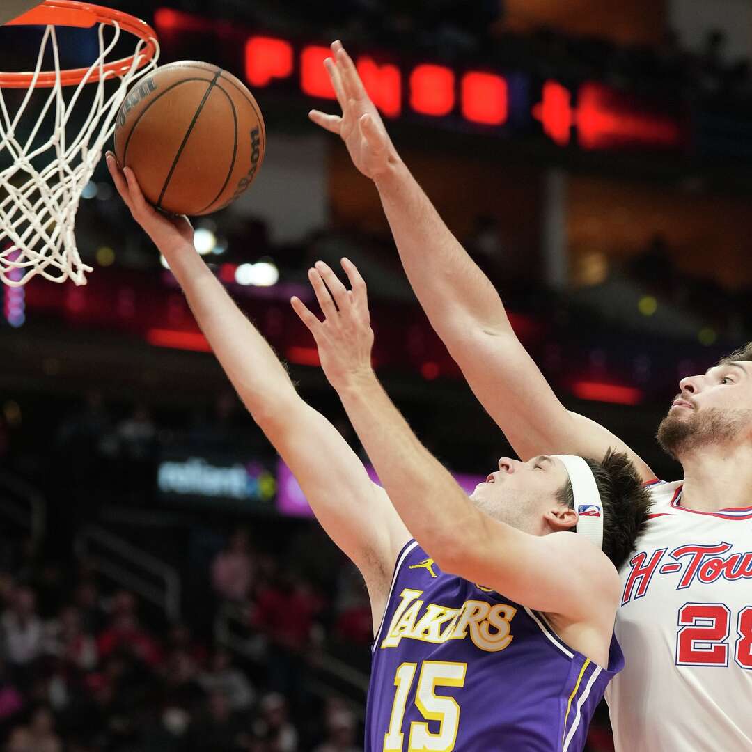 Los Angeles Lakers guard Austin Reaves (15) drives to the basket around Houston Rockets center Alperen Sengun (28) at the Toyota Center in Houston on Wednesday, March 18, 2026.