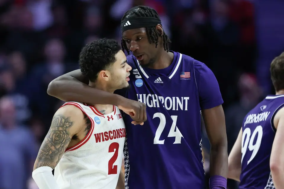 High Point center Youssouf Singare (24) and Wisconsin guard Nick Boyd (2) talk after the first round of the NCAA college basketball tournament Thursday, March 19, 2026, in Portland, Ore. (AP Photo/Amanda Loman)