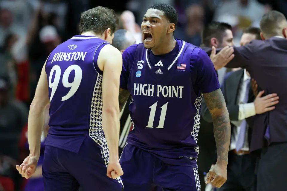 High Point forward Cam'ron Fletcher (11) celebrates with guard Chase Johnston (99) during the second half in the first round of the NCAA college basketball tournament against Wisconsin, Thursday, March 19, 2026, in Portland, Ore. (AP Photo/Amanda Loman)