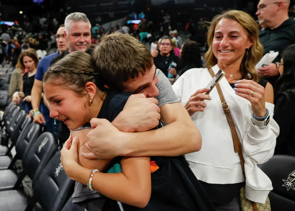 Cole Harrison hugs his sister Annie Harrison after the Spurs won at Frost Bank Center in San Antonio, Thursday, March 19, 2026. The Spurs won in the last second, 101-100.
