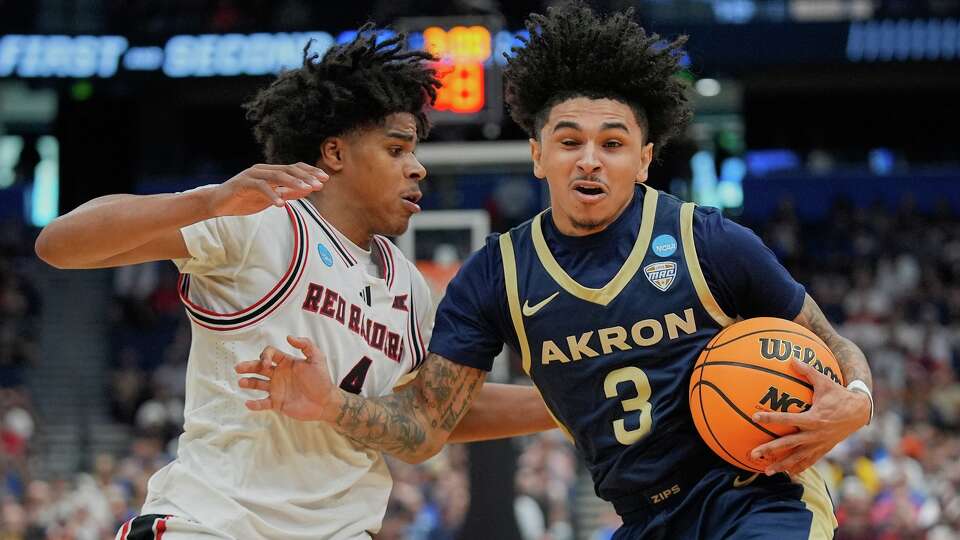 Akron guard Sharron Young (3) makes a move to get past Texas Tech guard Christian Anderson, left, during the first half in the first round of the NCAA college basketball tournament, Friday, March 20, 2026, in Tampa, Fla.
