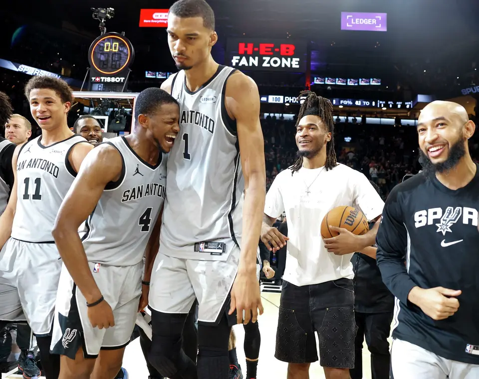 Spurs players celebrate after a last second win, 101-100, over the Phoenix Suns at Frost Bank Center in San Antonio, Thursday, March 19, 2026.