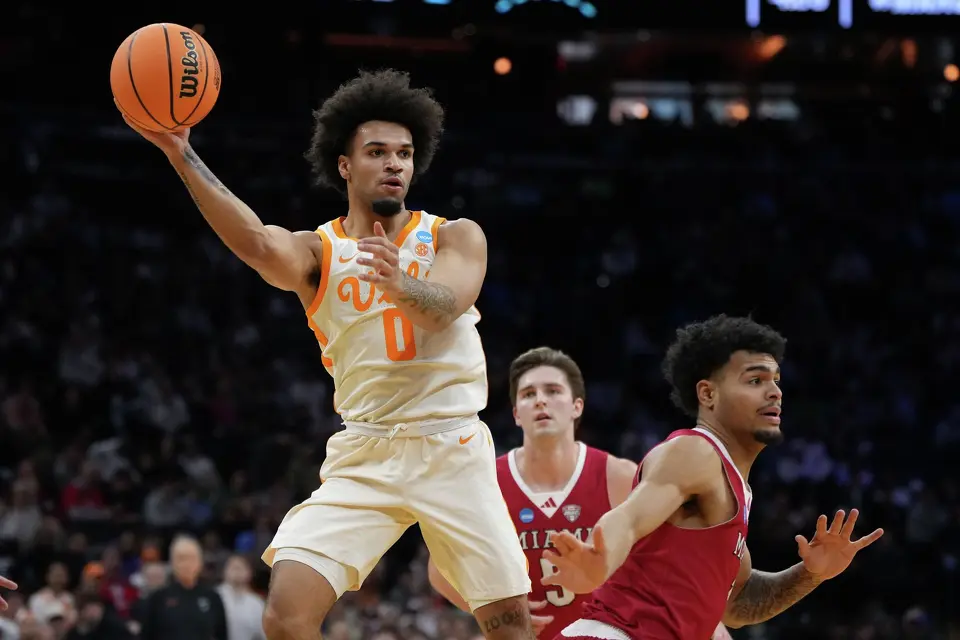 Tennessee's Ja'kobi Gillespie, left, passes behind Miami (Ohio)'s Trey Perry during the first half in the first round of the NCAA college basketball tournament, Friday, March 20, 2026, in Philadelphia.