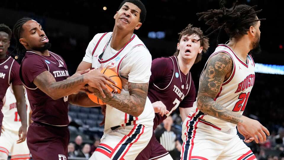 Houston center Chris Cenac Jr. (5) flights for a rebound against Texas A&M guard Marcus Hill (0) during the first half in the second round of the NCAA college basketball tournament in Oklahoma City, Saturday, March 21, 2026.
