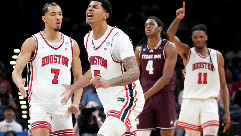 Houston guard Milos Uzan (7) reacts alongside center Chris Cenac Jr. (5) as a timeout is called by Texas A&M during the first half in the second round of the NCAA college basketball tournament in Oklahoma City, Saturday, March 21, 2026.