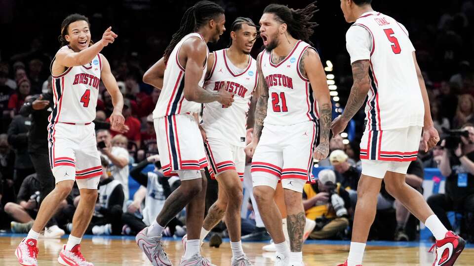 Houston guard Emanuel Sharp (21) reacts with teammates as a timeout is called by Texas A&M during the first half in the second round of the NCAA college basketball tournament in Oklahoma City, Saturday, March 21, 2026.