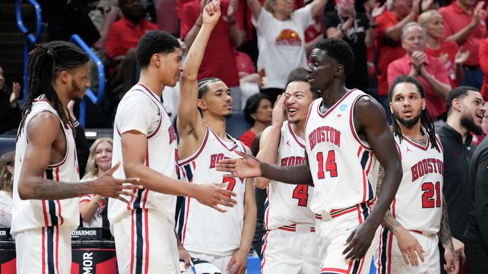 Houston forward Kalifa Sakho (14) gets a high-five from center Chris Cenac Jr. (5) and forward Joseph Tugler (11) as he heads to the bench during the second half in the second round of the NCAA college basketball tournament in Oklahoma City, Saturday, March 21, 2026.