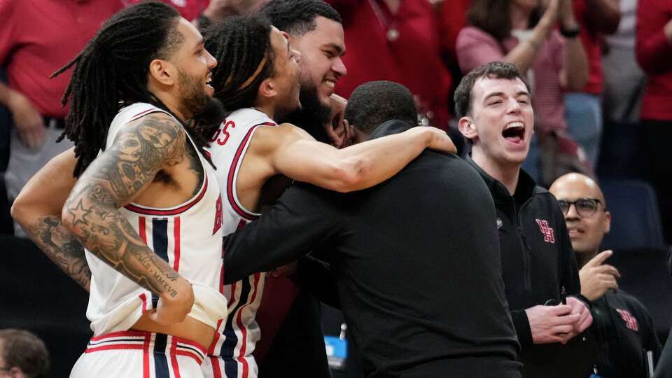 Houston players and coaches celebrate after the team's 88-57 win over Texas A&M during the second round of the NCAA college basketball tournament in Oklahoma City, Saturday, March 21, 2026.