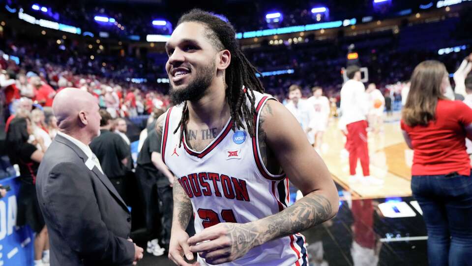 Houston guard Emanuel Sharp (21) runs off the court after the team's 88-57 win over Texas A&M in the second round of the NCAA college basketball tournament in Oklahoma City, Saturday, March 21, 2026.