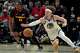 Golden State Warriors guard Brandin Podziemski (2) chases a loose ball with Atlanta Hawks forward Jonathan Kuminga (0) during the first half of an NBA basketball game, Saturday, March 21, 2026, in Atlanta. (AP Photo/Mike Stewart)