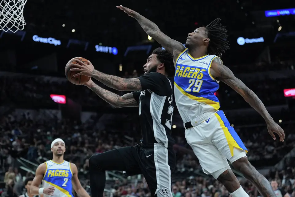 San Antonio Spurs forward Julian Champagnie (30) drives to the basket past Indiana Pacers guard Quenton Jackson (29) during the first half of an NBA basketball game in San Antonio, Saturday, March 21,2026. (AP Photo/Eric Gay)