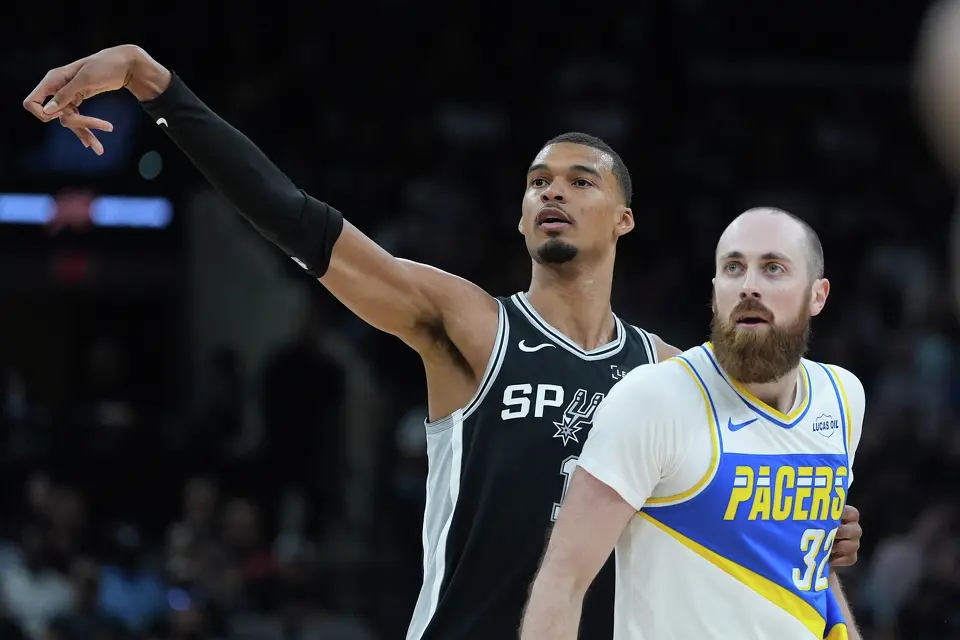 San Antonio Spurs forward Victor Wembanyama (1) stands next to Indiana Pacers center Jay Huff (32) as he watches his shot during the first half of an NBA basketball game in San Antonio, Saturday, March 21,2026. (AP Photo/Eric Gay)