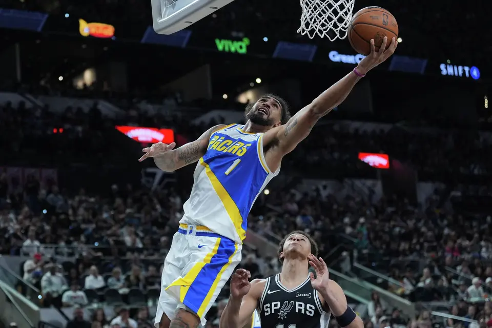 Indiana Pacers forward Obi Toppin (1) drives to the basket over San Antonio Spurs forward Carter Bryant (11) during the second half of an NBA basketball game in San Antonio, Saturday, March 21,2026. (AP Photo/Eric Gay)