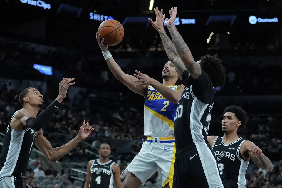 Indiana Pacers guard Andrew Nembhard (2) drives to the basket past San Antonio Spurs forward Julian Champagnie (30) and forward Victor Wembanyama (1) during the second half of an NBA basketball game in San Antonio, Saturday, March 21,2026. (AP Photo/Eric Gay)
