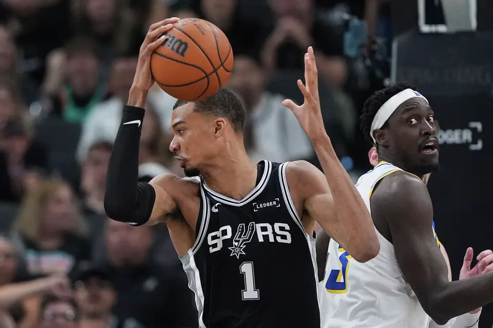 San Antonio Spurs forward Victor Wembanyama (1) grabs a rebound in front of Indiana Pacers forward Pascal Siakam (43) during the second half of an NBA basketball game in San Antonio, Saturday, March 21,2026. (AP Photo/Eric Gay)