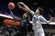 West Haven's Loshon Roman (4) gets a shot off in front of Staples' Dhilan Lowman (23) during their CIAC Division I boys basketball final Saturday, March 21, 2026 at Mohegan Sun Arena in Uncasville, Conn.