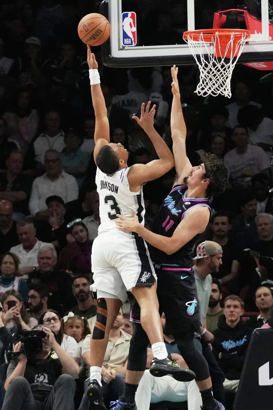 San Antonio Spurs forward Keldon Johnson (3) shoots over Miami Heat forward Jaime Jaquez Jr. (11) during the second half of an NBA basketball game, Monday, March 23, 2026, in Miami. (AP Photo/Lynne Sladky)